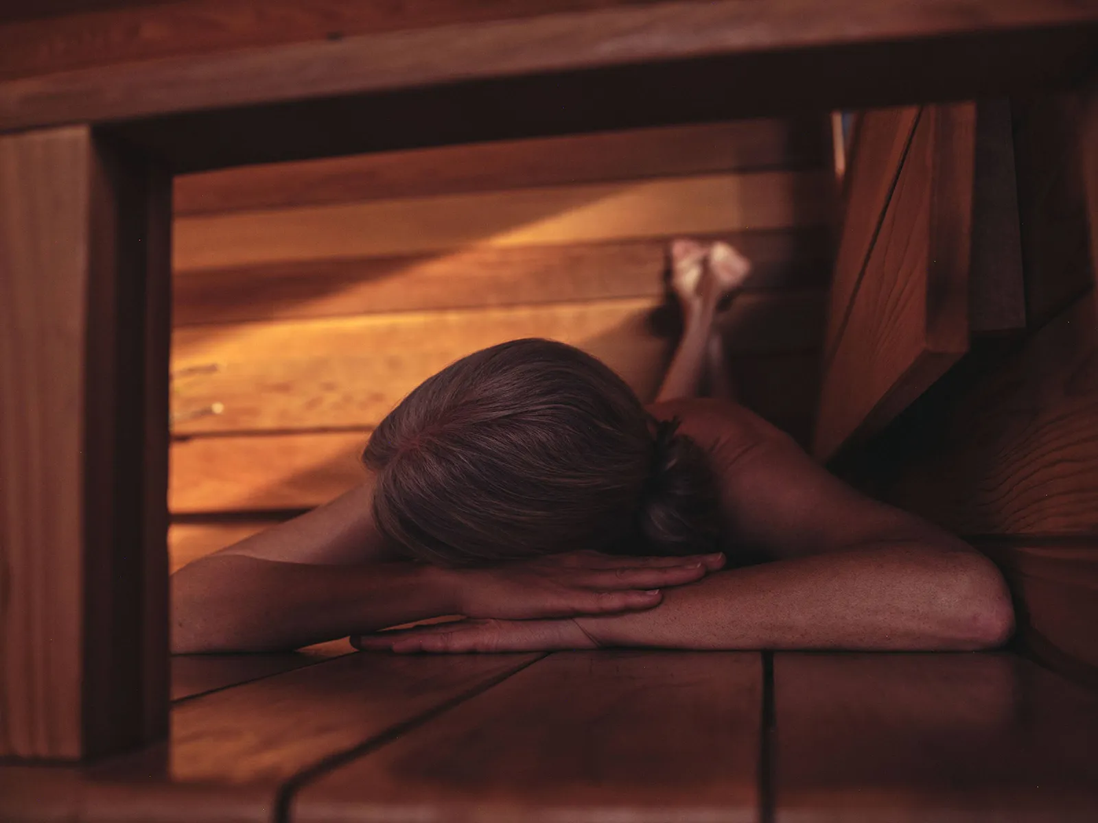 Woman relaxing in a Wildhut luxury 6 person Sauna