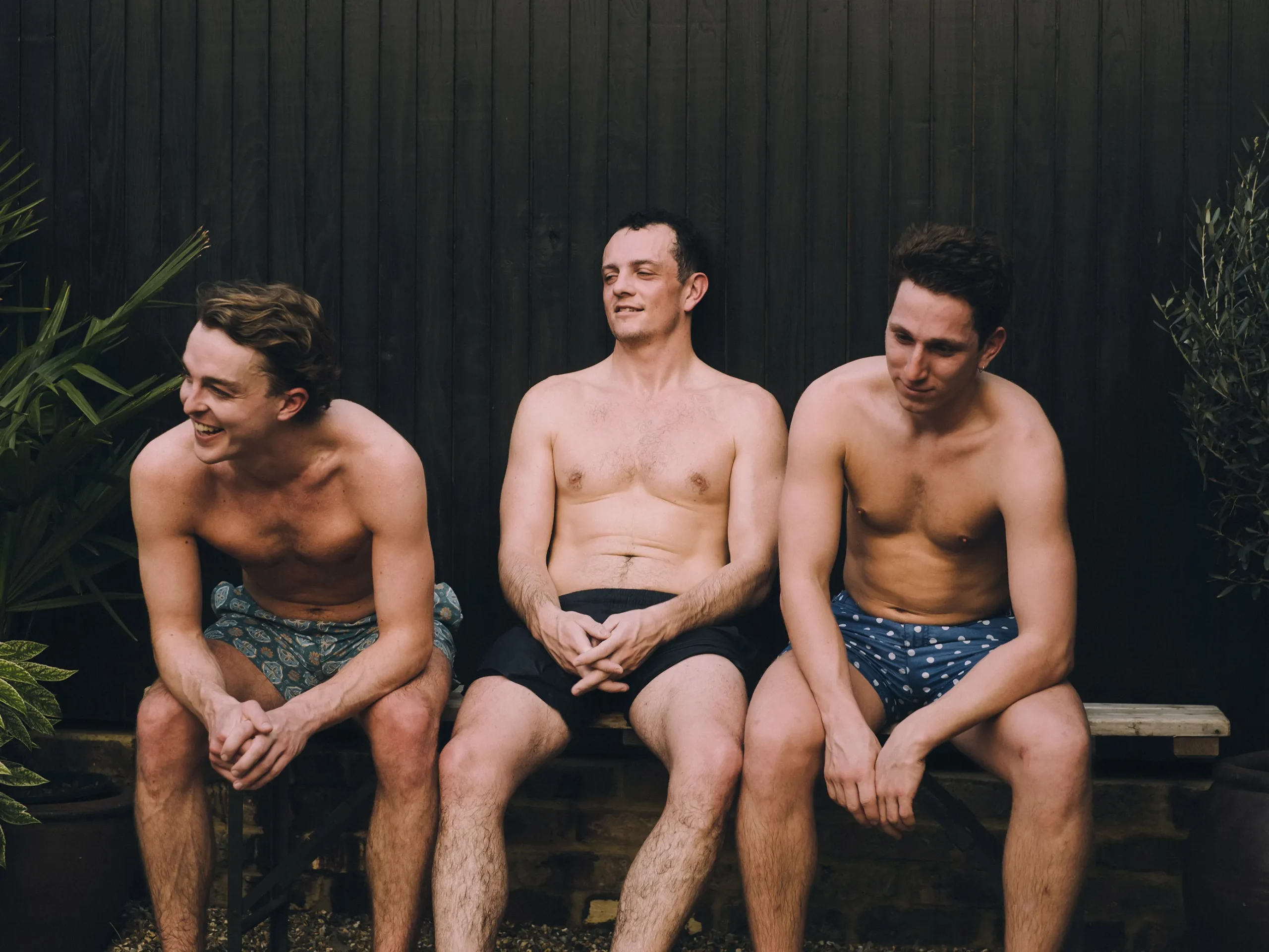 Three Men relaxing outside a Wildhut outdoor Sauna